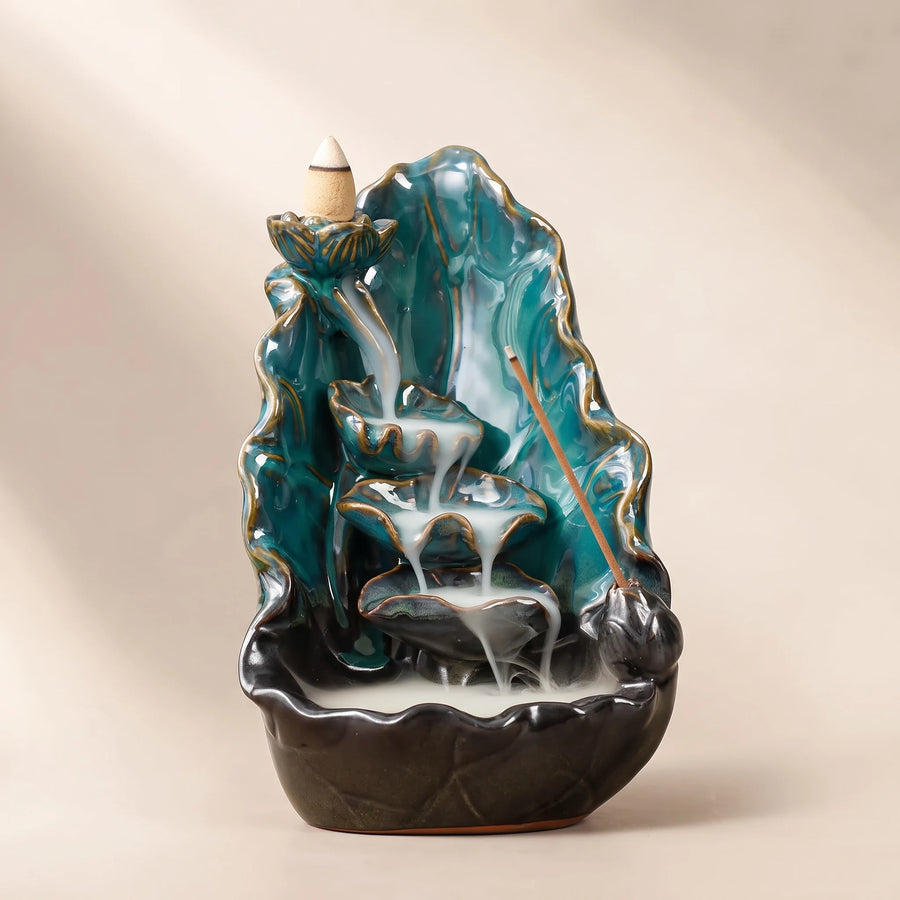 Blue glaze backflow incense burner shaped like a wide lotus leaf over a dark basin