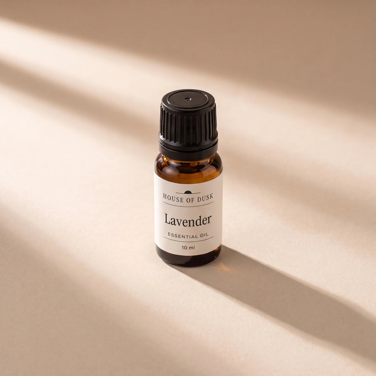 10 ml amber glass essential oil bottle with a black cap seen from above